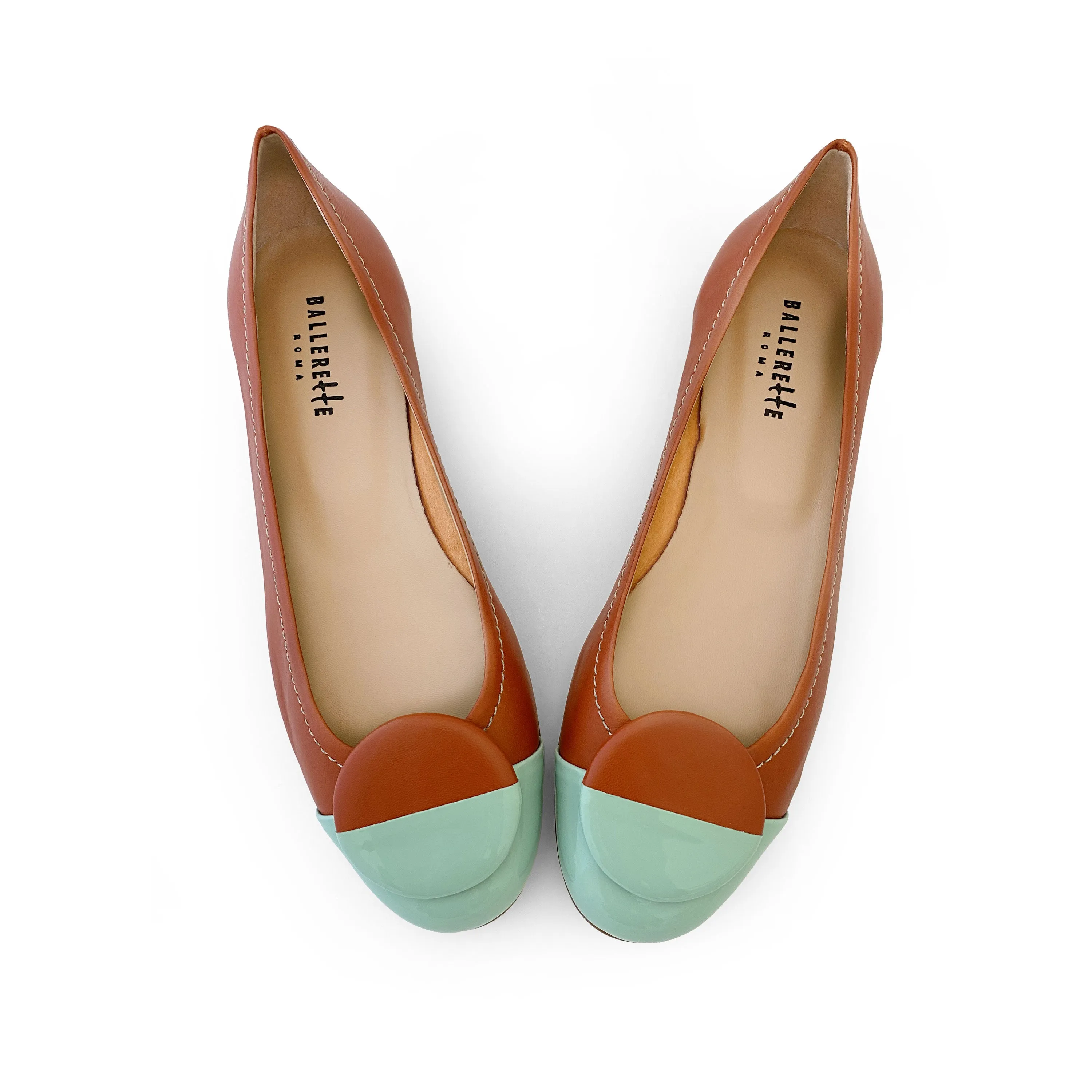 Tan leather ballet flats with green patent leather toe and stud