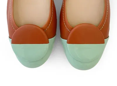 Tan leather ballet flats with green patent leather toe and stud