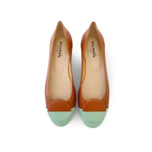 Tan leather ballet flats with green patent leather toe and stud